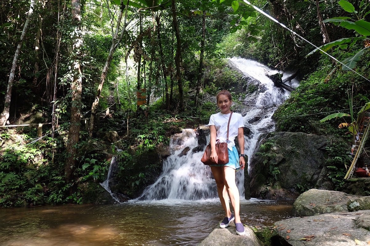 A tourist enjoying at the Mae Takhrai waterfall in Chiang Mai