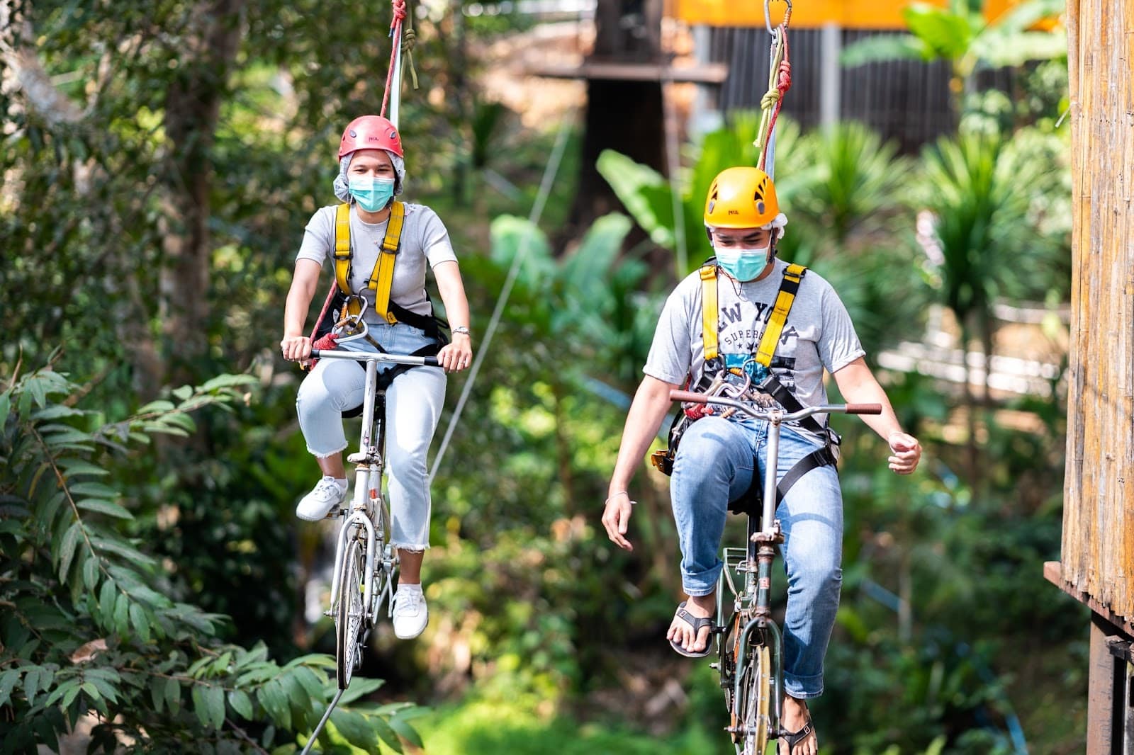 Two friends enjoying aerial cycling at Pongyang Zipline and Jungle Coaster