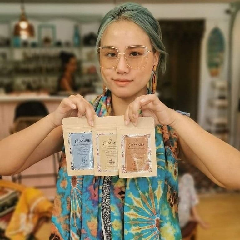 A girl holding Kali Cannabis products