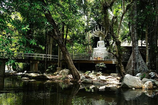 Waterfall and Lake Circling Around Budhha Statue in Hin Lad Waterfall Temple