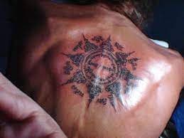 Tattooing Buddhist Symbol on Man’s Back at Krabi Tattoo & Body Piercing