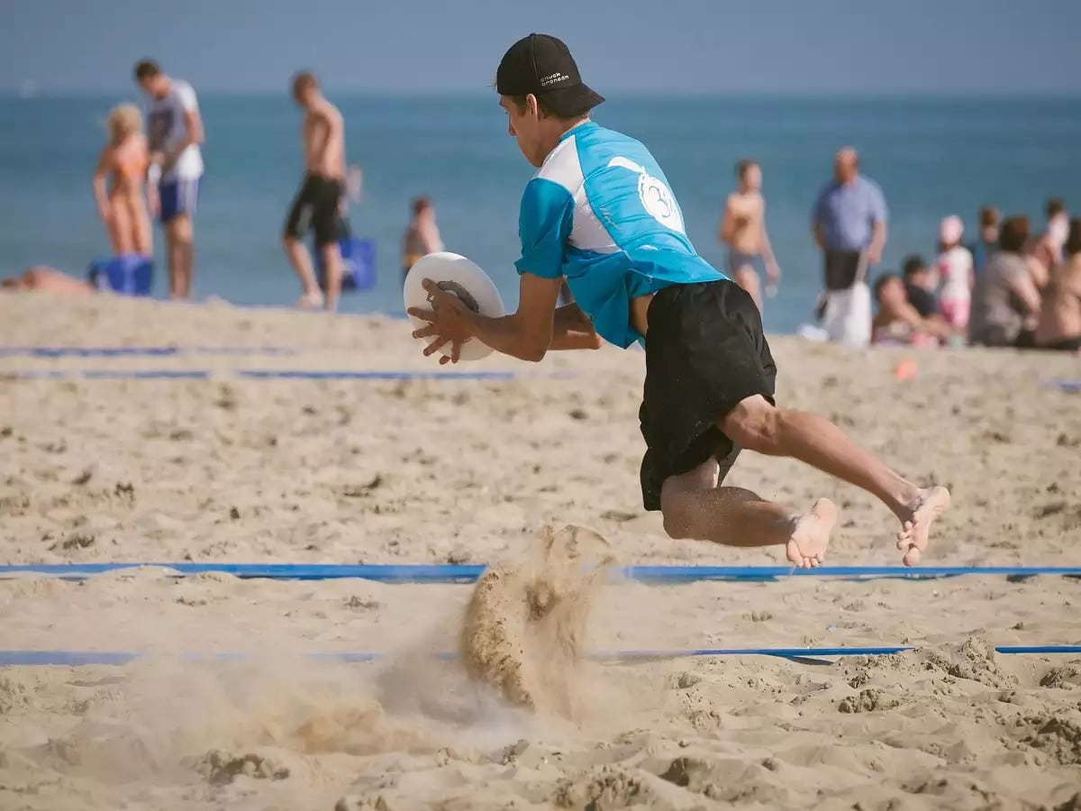 People Playing Frisbee on Relax Beach