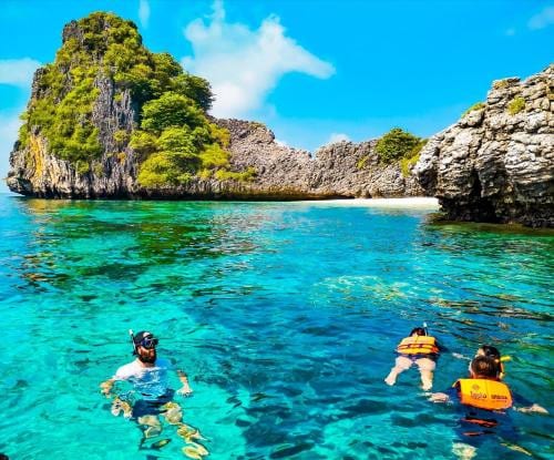 Visitors enjoying swimming on Kantiang Beach, Koh Lanta