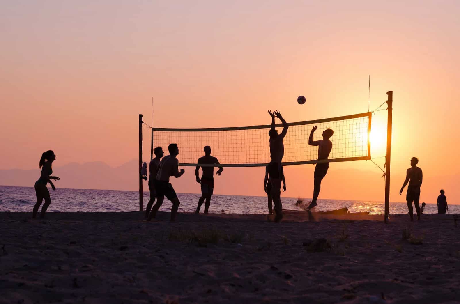 A group of friends enjoying volleyball on Laem Kho Kwang Beach
