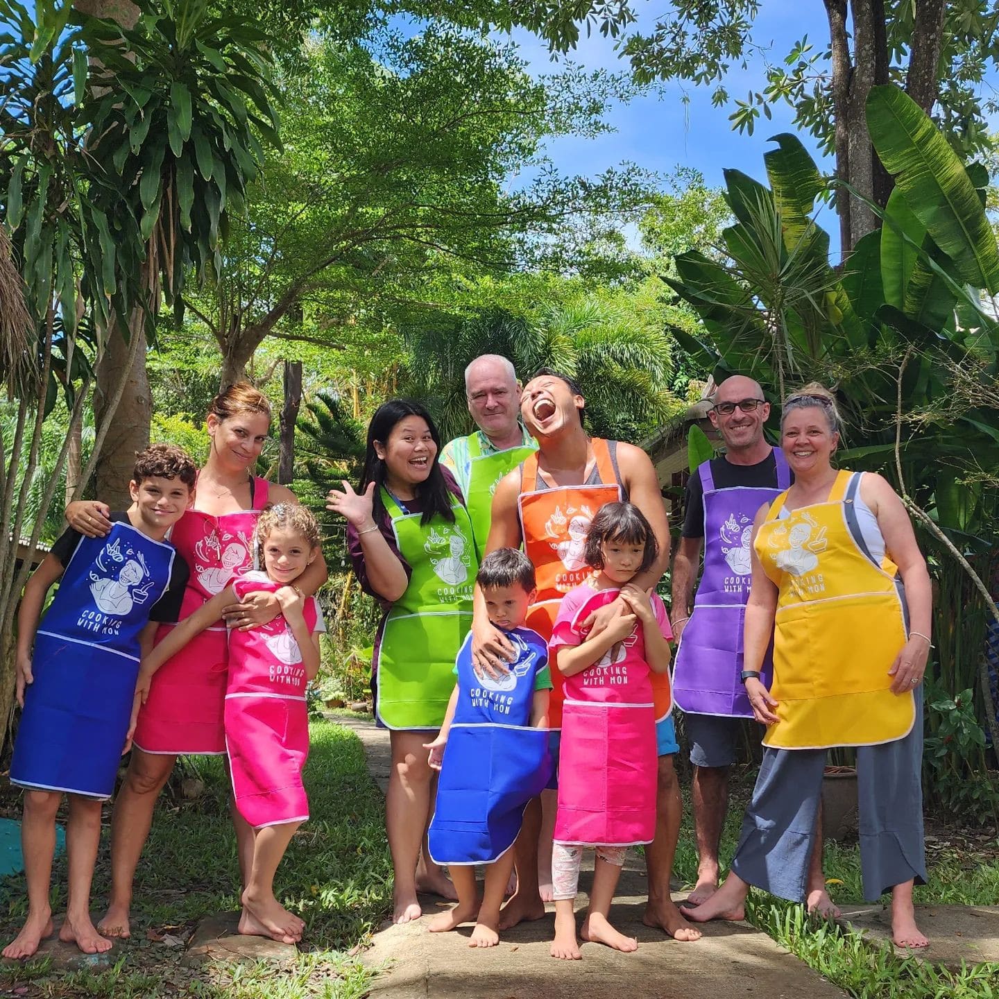 A group of visitors posing after the class at Cooking with Mon