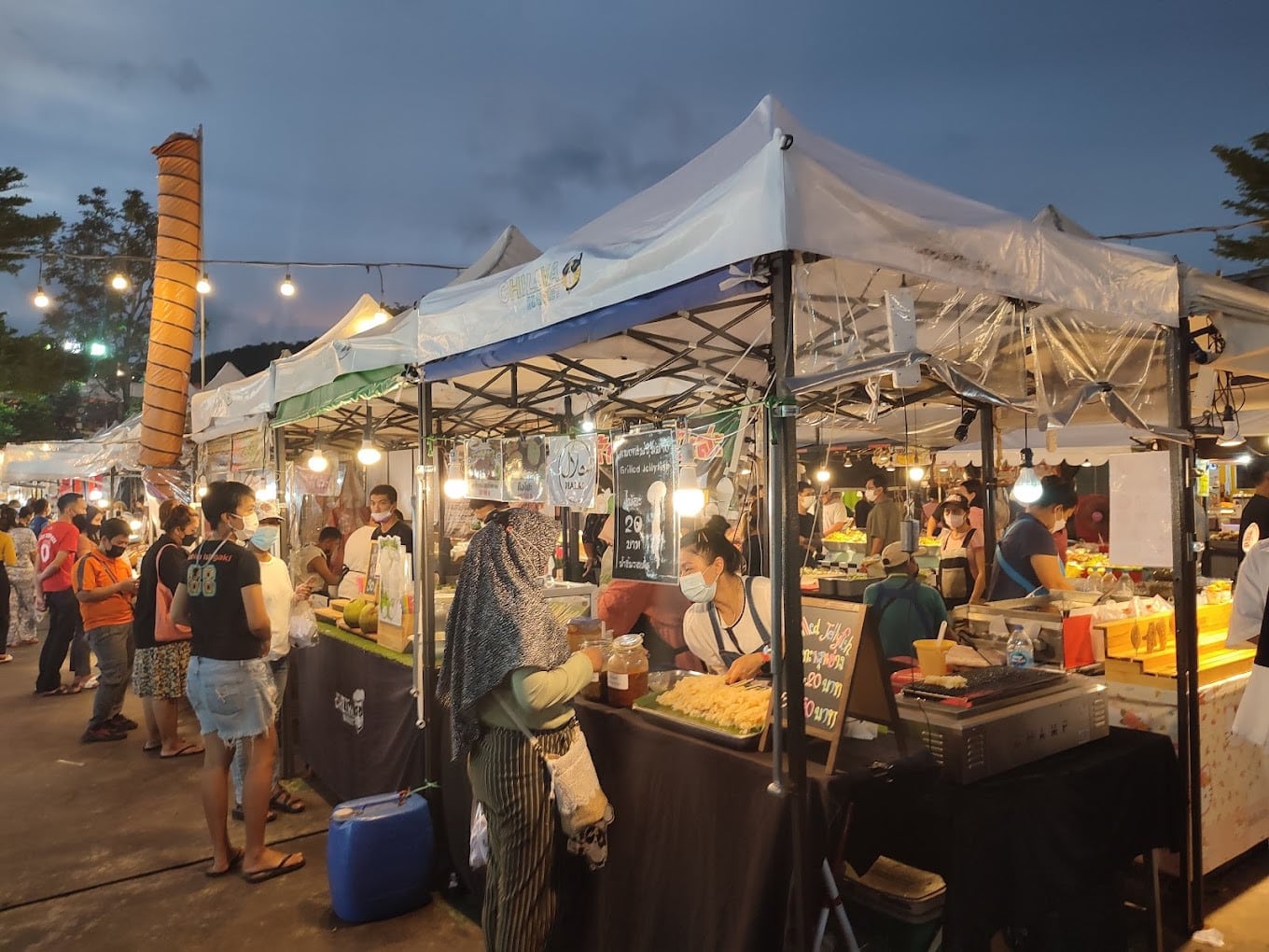 Visitors enjoying delicious meals at Chillva Market, Phuket Visitors Enjoying Delicious Meals At Chillva Market Phuket
